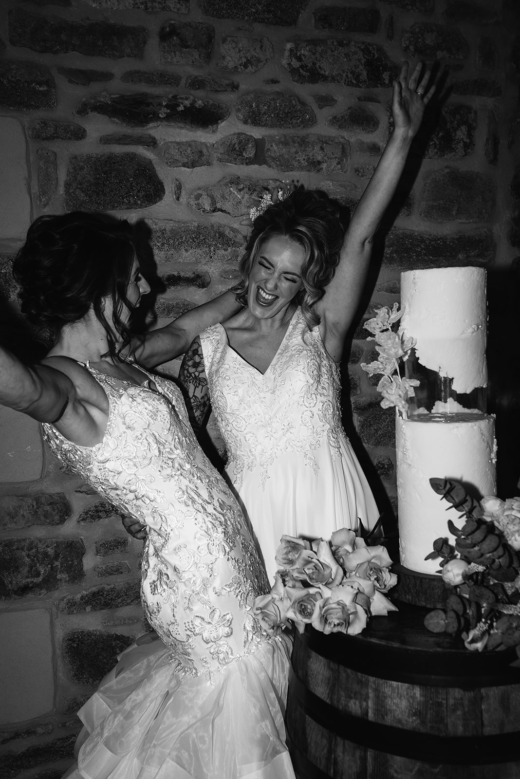 2 brides celebrating with thier wedding cake at Schivas Steading in Aberdeenshire